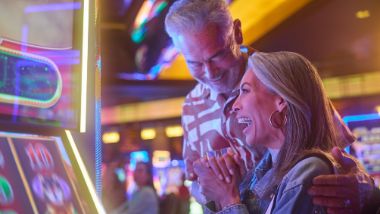 couple playing on slot machine