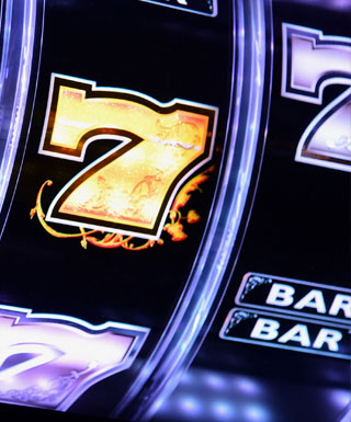 Close-up of a video poker machine showing a golden number 7 at Hollywood Casino Joliet.