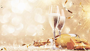 gold fireworks with champagne glasses and bottle